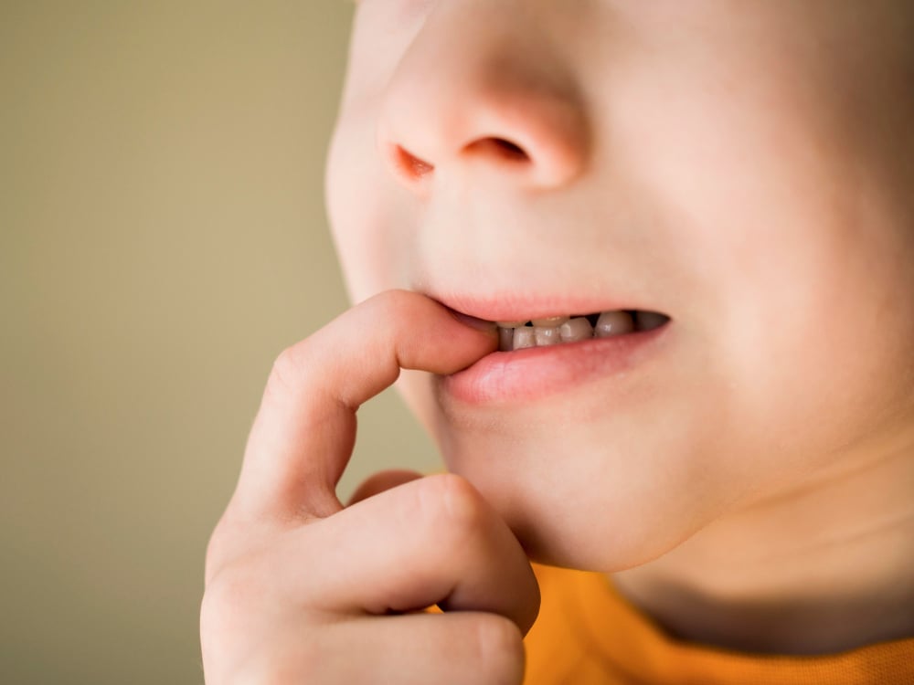 Child Biting Fingernail in Nervous Moment