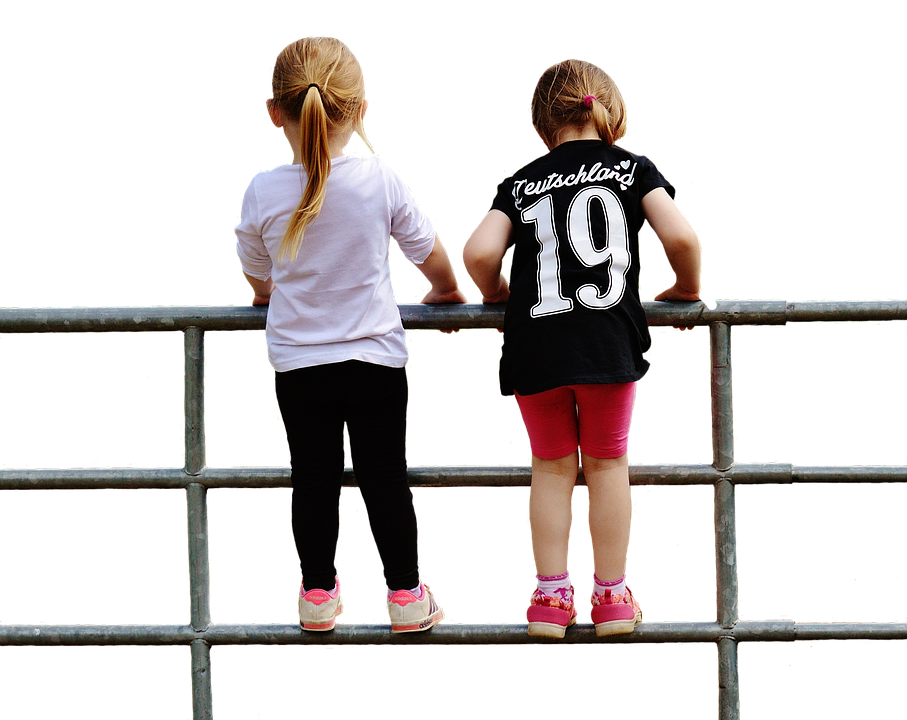 Two Children Gazing Over a Fence