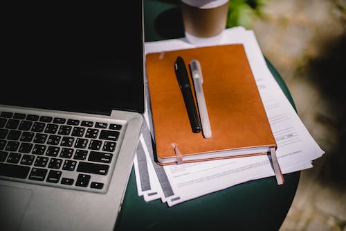 Workspace With Laptop And Notebook